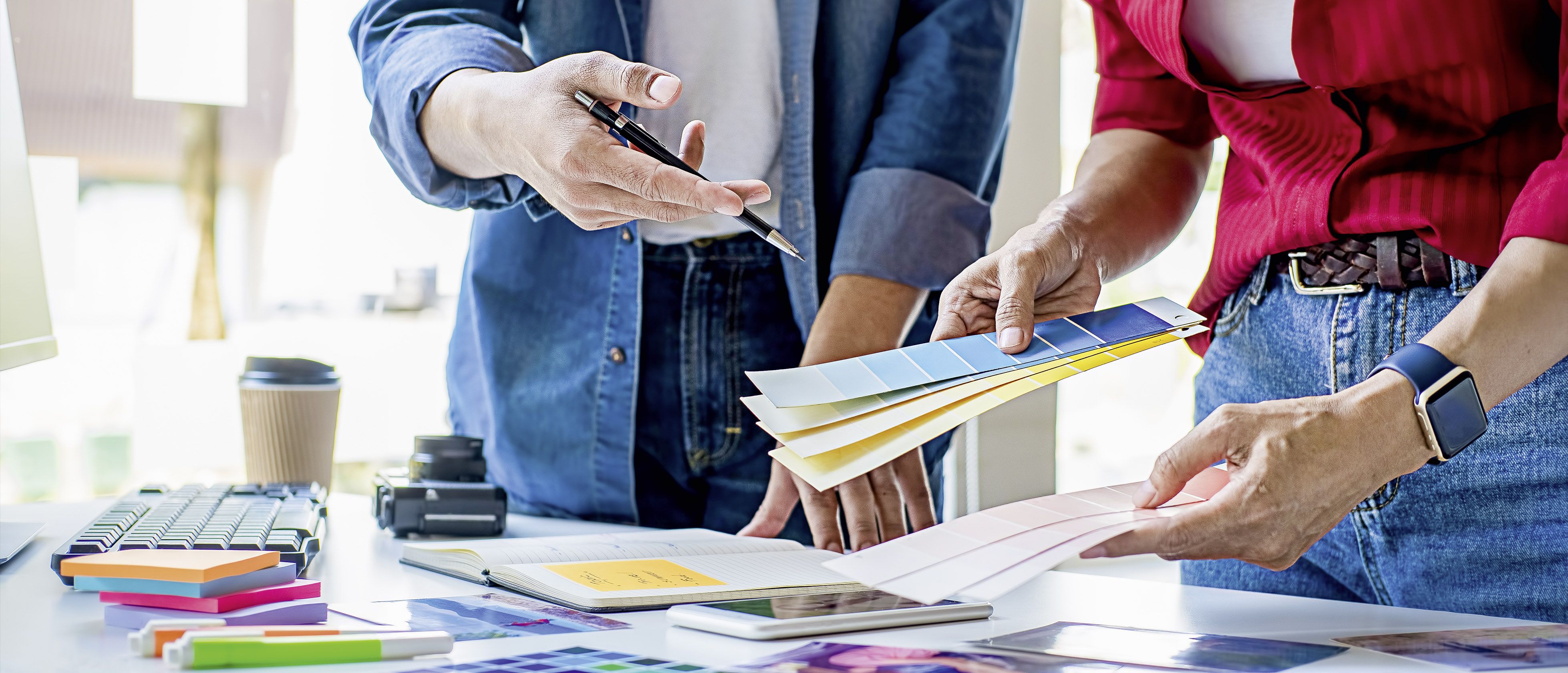 Symbolbild Mediengestalter mit Farbfächern in der Druckvorstufe